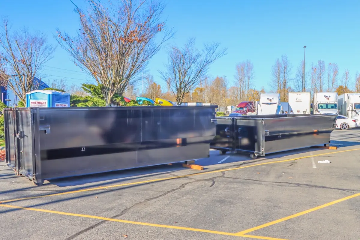 Professional dumpster rental service with roll-off container on residential driveway in Florida Ridge